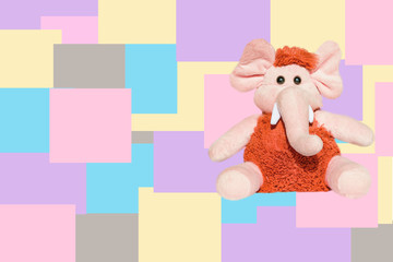 Soft toy beige with brown wool mammoth elephant isolated on colored background,
