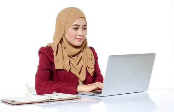 Portrait of pretty Asian hijap woman in front of laptop