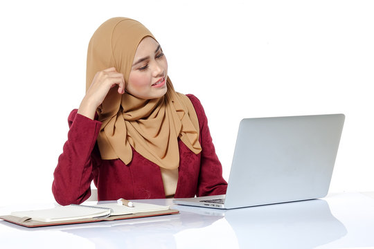 Portrait of pretty Asian hijap woman in front of laptop