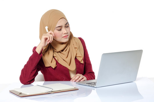 Portrait of pretty Asian hijap woman in front of laptop