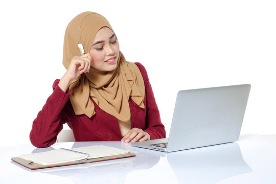 Portrait of pretty Asian hijap woman in front of laptop