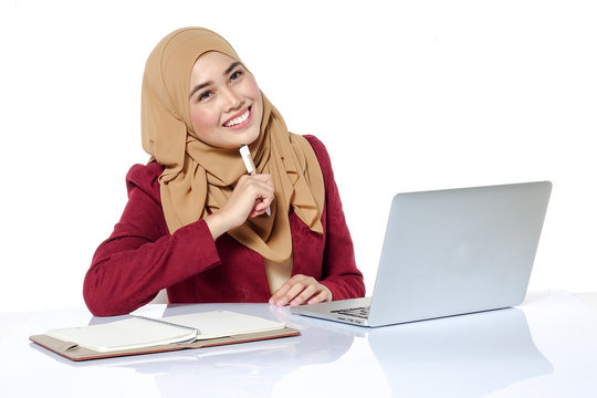 Portrait of pretty Asian hijap woman in front of laptop