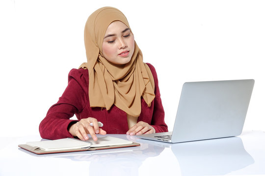 Portrait of pretty Asian hijap woman in front of laptop