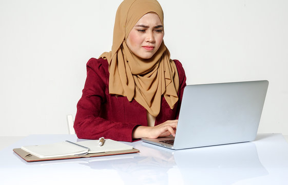 Portrait of pretty Asian hijap woman in front of laptop