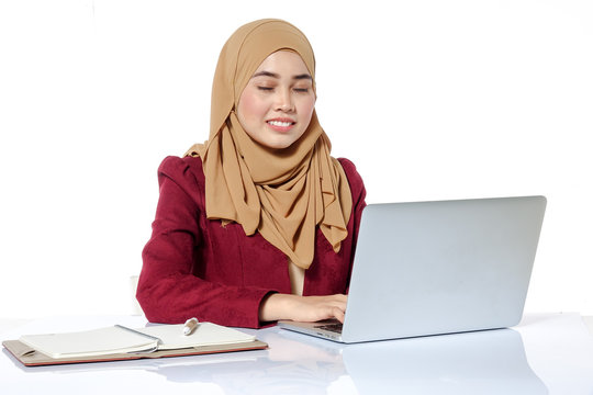 Portrait of pretty Asian hijap woman in front of laptop
