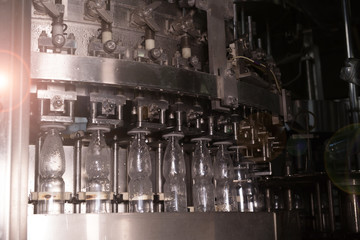 Factory and production concept - conveyor for bottling water from plastic bottles