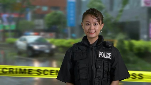 Asian American Woman Police Officer Smiles at Camera