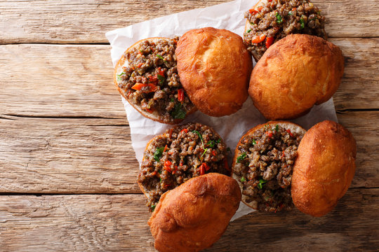 Delicious South African Vetkoek fried donuts stuffed with minced meat close-up. horizontal top view