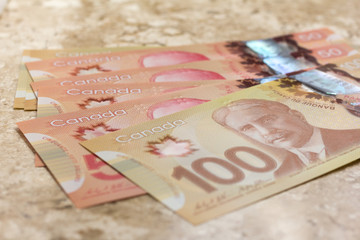 Paper notes from Canada. Dollar. Closeup on marble table.