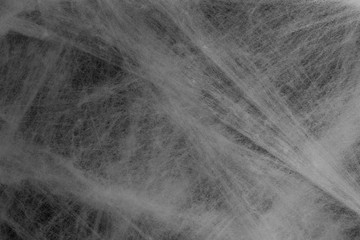 Halloween background concept. Full frame of cobweb on black backdrop.