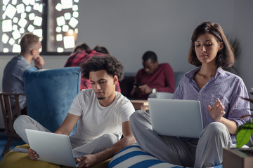 Fototapeta premium business, startup, technology and people concept - happy international creative team with laptop and tablet pc computer at office