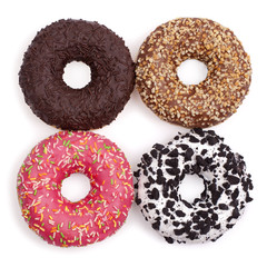 Multicolored donuts on a white background top view