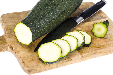 Zucchini on kitchen cutting board, sliced, ingredients for cooking