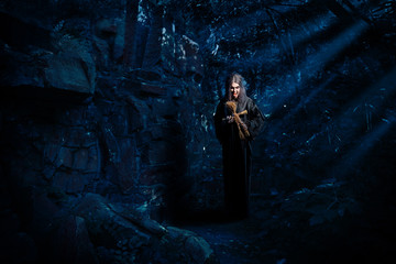 Witch in night forest