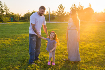 Naklejka na ściany i meble Friendly family walking in the park and have fun together