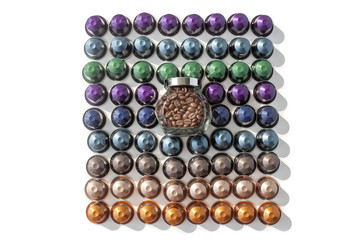 Coffee capsules different kinds and colors and coffee beans in glass jar on a white background top view isolated