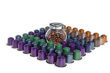 Coffee capsules different kinds and colors and coffee beans in glass jar on a white background isolated