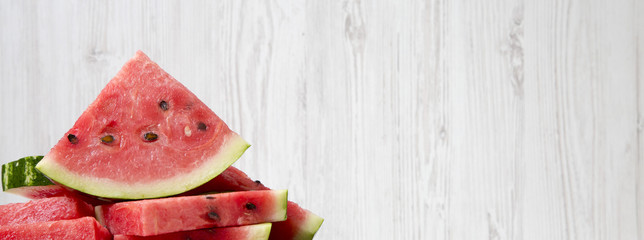 Many slices of ripe juicy watermelon, close-up. Side view. Copy space.