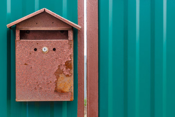 A beautiful mailbox hangs waiting for newspapers, parcels and letters.