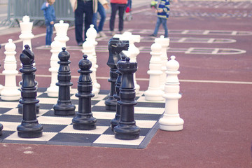 background, outdoor life-size chess stand on the sea promenade