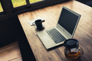 laptop on wooden desk