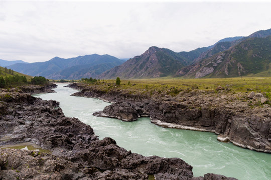Mountain river landscape. Oasis in the desert. Trees and mountains on the banks of the river Khovd at Western Mongolia. Khovd valley