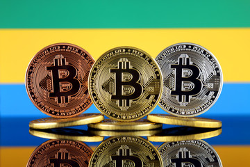 Physical version of Bitcoin (BTC) and Gabon Flag. Conceptual image for investors in High Technology...