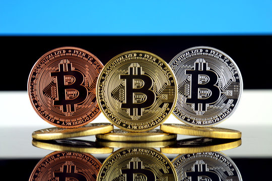 Physical version of Bitcoin (BTC) and Estonia Flag. Conceptual image for investors in High Technology (Cryptocurrency, Blockchain Technology, Smart Contracts, ICO).