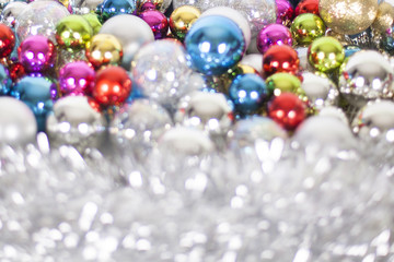 Christmas and New Year pattern, ornament of bright different colors glass decorative balls and tinsel, lights and sparkles