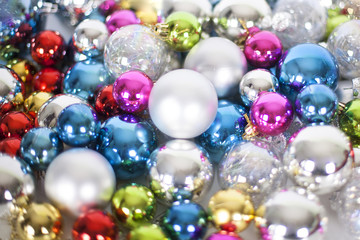 Christmas and New Year pattern, ornament of bright different colors glass decorative balls and tinsel, lights and sparkles, close-up