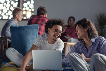 Fototapeta premium business, startup, technology and people concept - happy international creative team with laptop and tablet pc computer at office