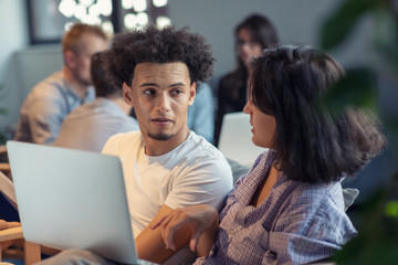 startup business and new mobile technology concept with young multiethnic couple in modern bright...