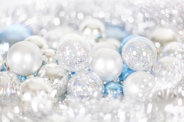 Obraz na płótnie Canvas Christmas and New Year pattern, ornament of Christmas balls and tinsel, winter fairytale decor in blue and white color, lights bokeh