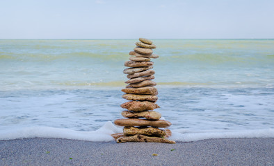 Stone tower in the sea waves
