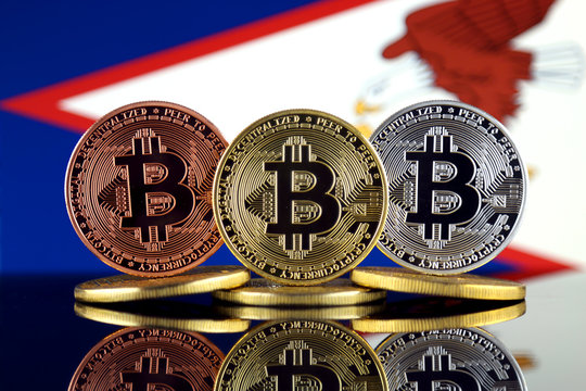 Physical version of Bitcoin (BTC) and American Samoa Flag. Conceptual image for investors in High Technology (Cryptocurrency, Blockchain Technology, Smart Contracts, ICO).