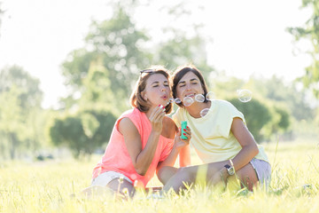 Two girl laughing on grass