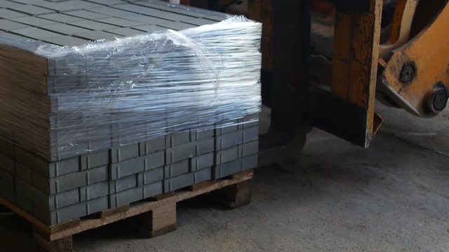 The loader takes away the finished interlocking concrete pavers
