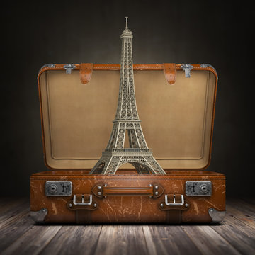 Trip to Paris. Travel or tourism to France concept. Eiffel tower and vintage suitcase.
