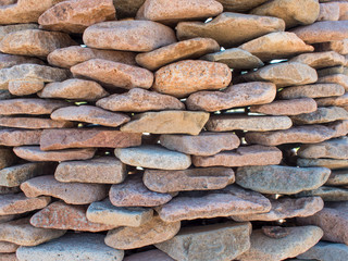 texture of wall of pebbles, wall is folded by hand from flat stones