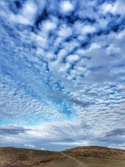 Blue sky with white cirrus clouds. Beautiful natural landscape.