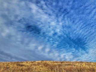 Blue sky with white cirrus clouds. Beautiful natural landscape.