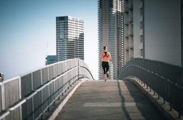 Fototapeta na wymiar Young female jogging in the city. 