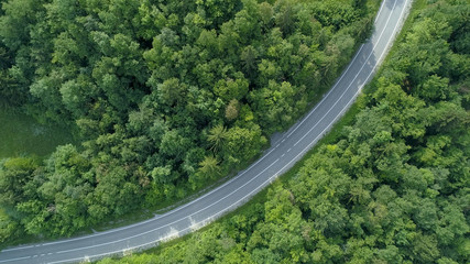 AERIAL TOP DOWN: Cinematic view of empty country road in rural part of Slovenia.