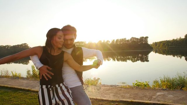 Concept of love and relationships Couple dancing bachata at sunset
