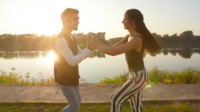 Concept of love and relationships Couple dancing bachata at sunset