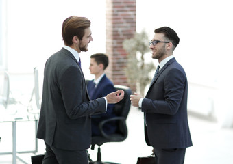 Two employees in business suits work in a conference hall