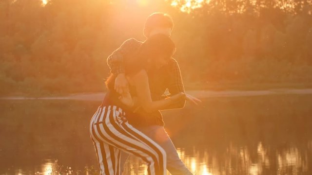Concept of love and relationships Couple dancing bachata at sunset