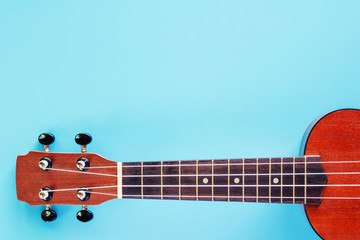 Ukulele on blue background for musical instrument, hobbies and relaxation concept