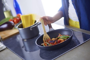 Young woman in the kitchen preparing a food