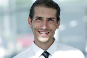 face of young businessman on background of office